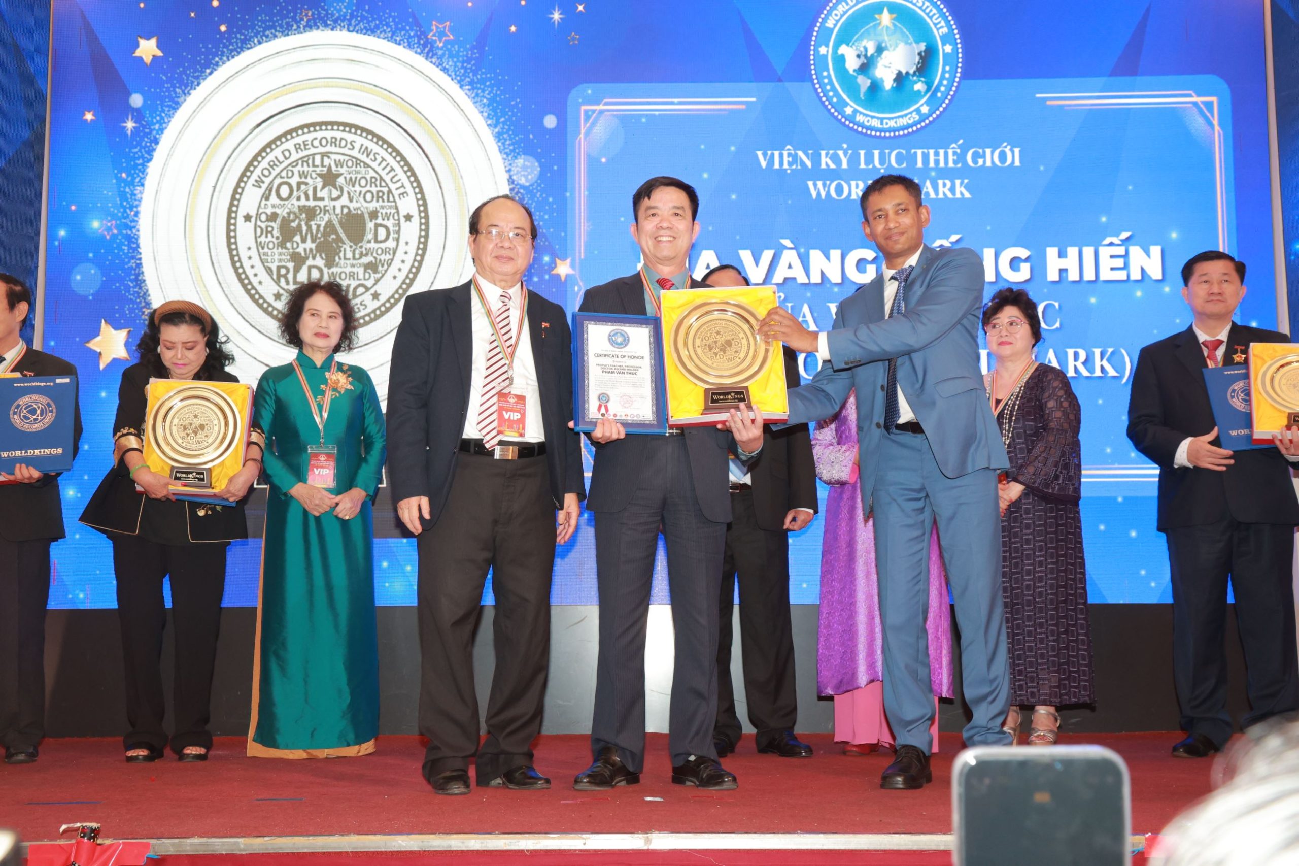 Tiến sĩ Biswaroop Roy Chowdhury và Giáo sư, Viện sĩ Hoàng Quang Thuận  trao chứng nhận và Đĩa vàng Cống hiến đến Nhà giáo Nhân dân, Giáo sư, Tiến sĩ, Kỷ lục gia Phạm Văn Thức. 